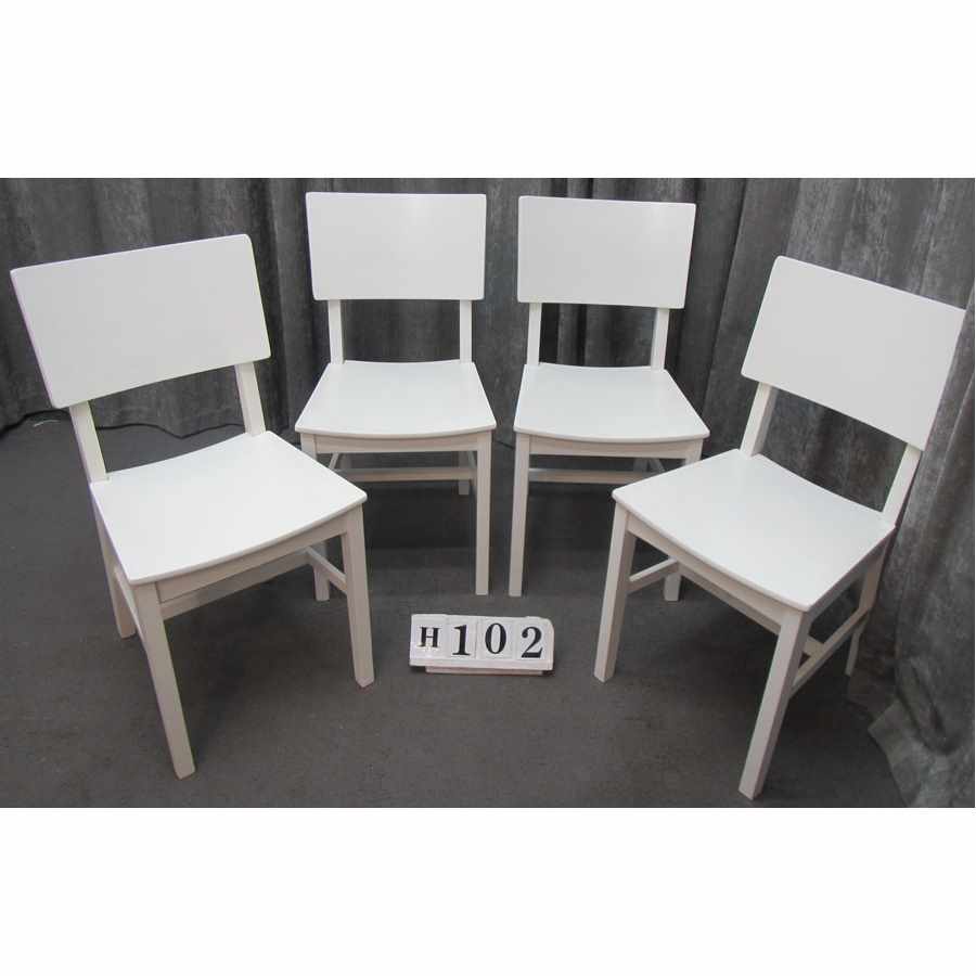 Set of four white chairs.
